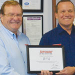 From left: Michael Lamers awarding Warren Wilson the HSS Master Distributor certificate.